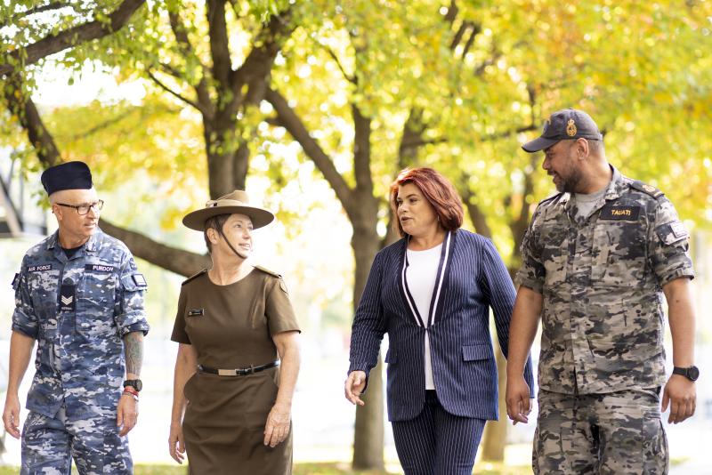 ADF members and an APS staff member walk together chatting